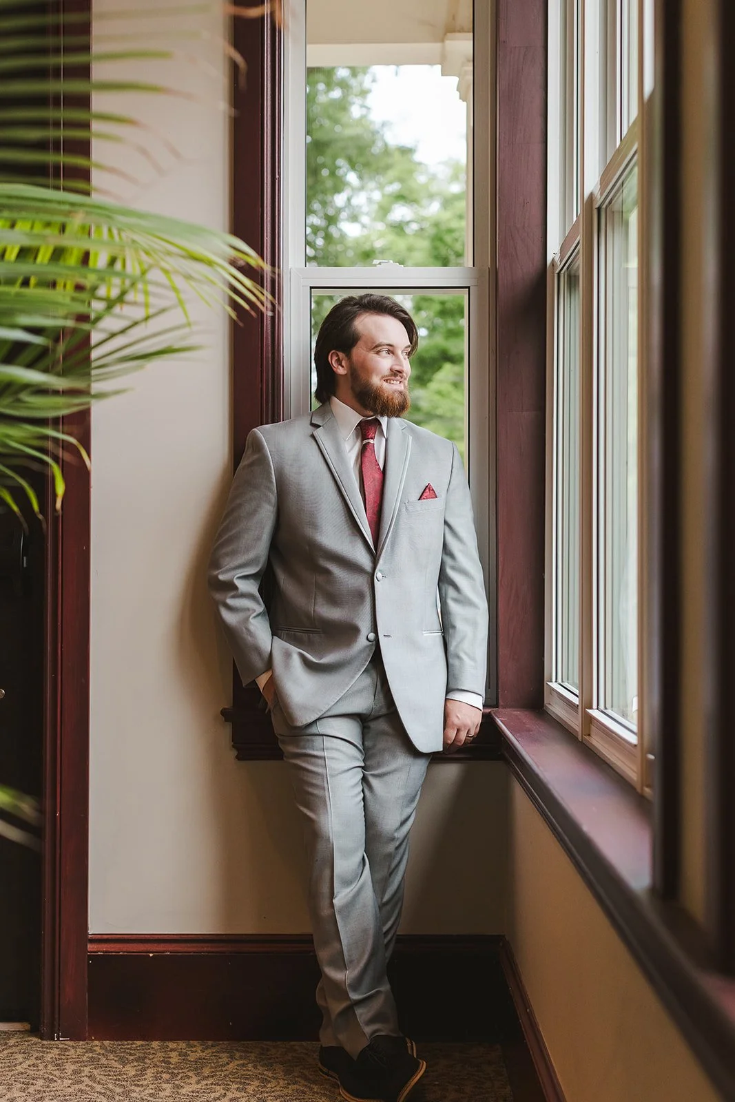 Groom leabing against window  Puddicombe House  New Hamberg, ON  Fedora Media.jpg