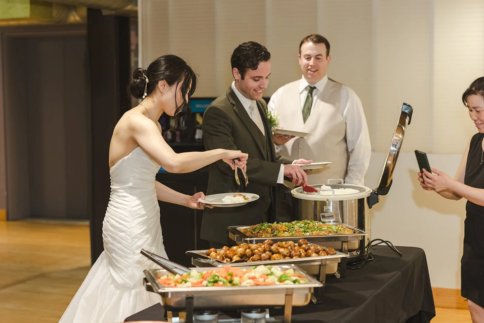Bride and Groom at buffet during wedding reception  Kitchener, ON  THE museum  Fedora Media.jpg