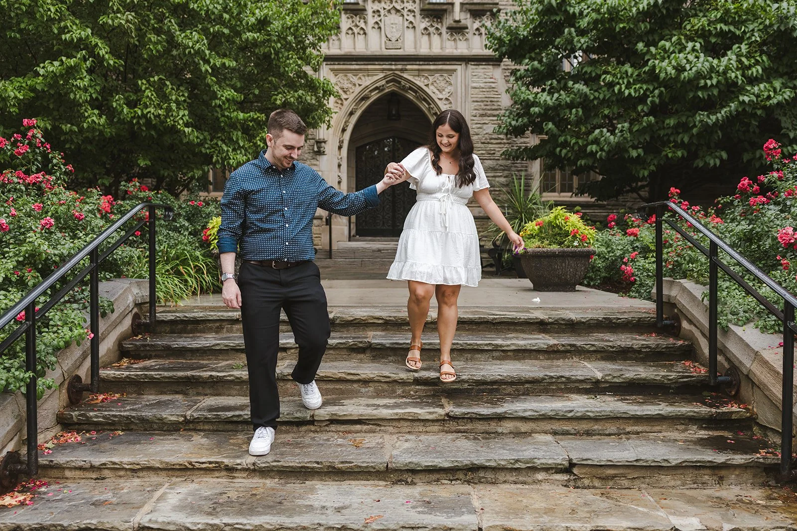 Engaged couple walking down stairs  Fedora Media.jpg
