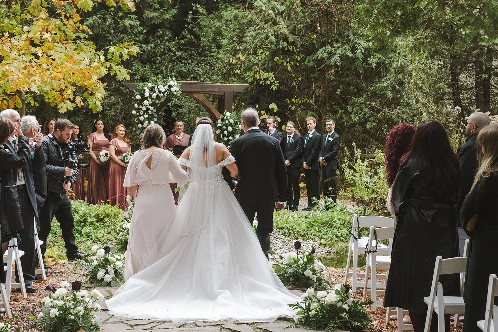 Bride's parents walking her down the aisle toward altar  Erin Estates  Fedora Media.jpg