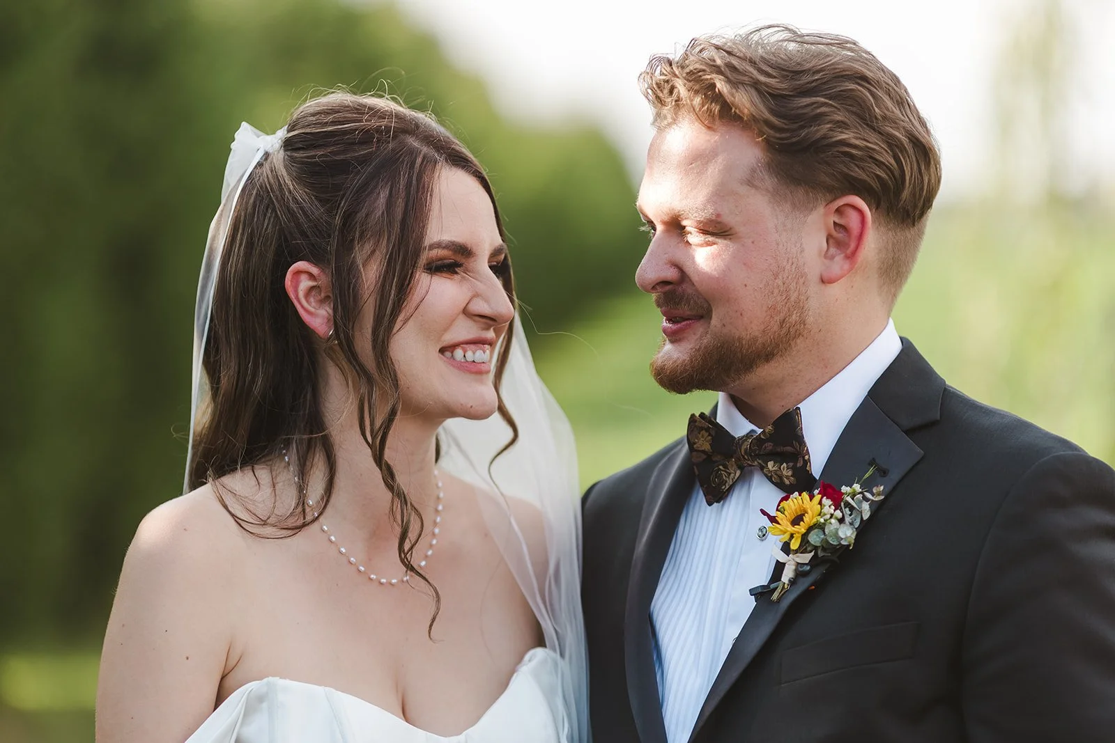 Bride and groom share intimate smiles  Barn Swallows at Thatcher Farm  Fedora Media.jpg