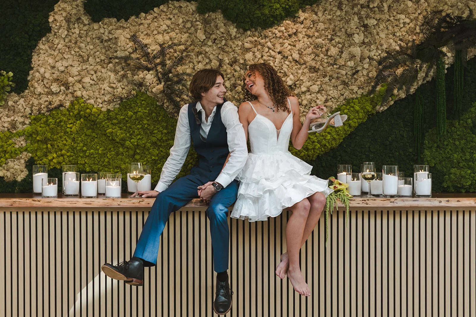 Bride and Groom sitting on bar top smiling and laughing together  Urban Jungle  Black Shop Restaurant  Cambridge, ON  Fedora Media.jpg