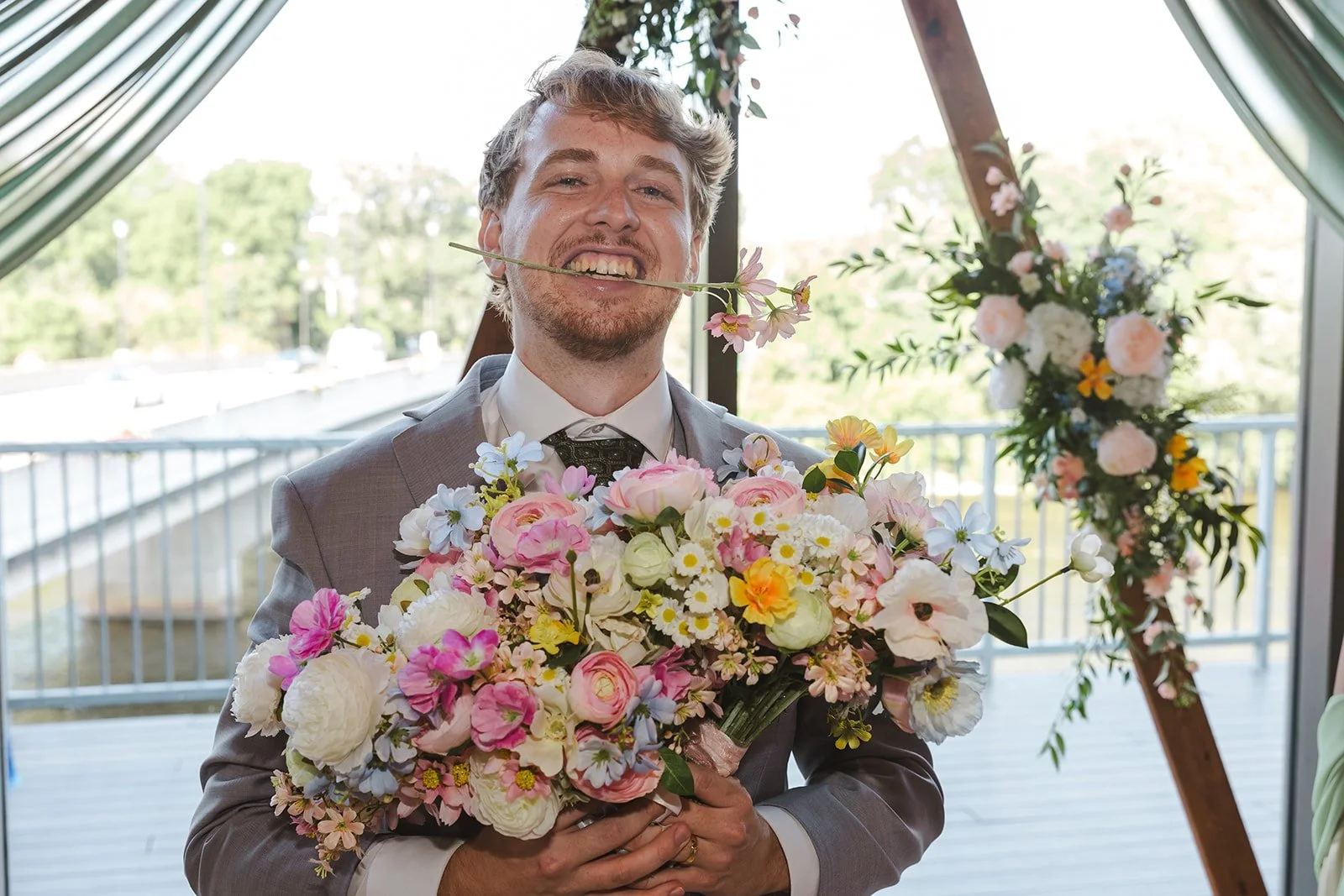 Groom holding flowers  River's Edge  Arlington Hotel  Paris, ON  Fedora Media.jpg