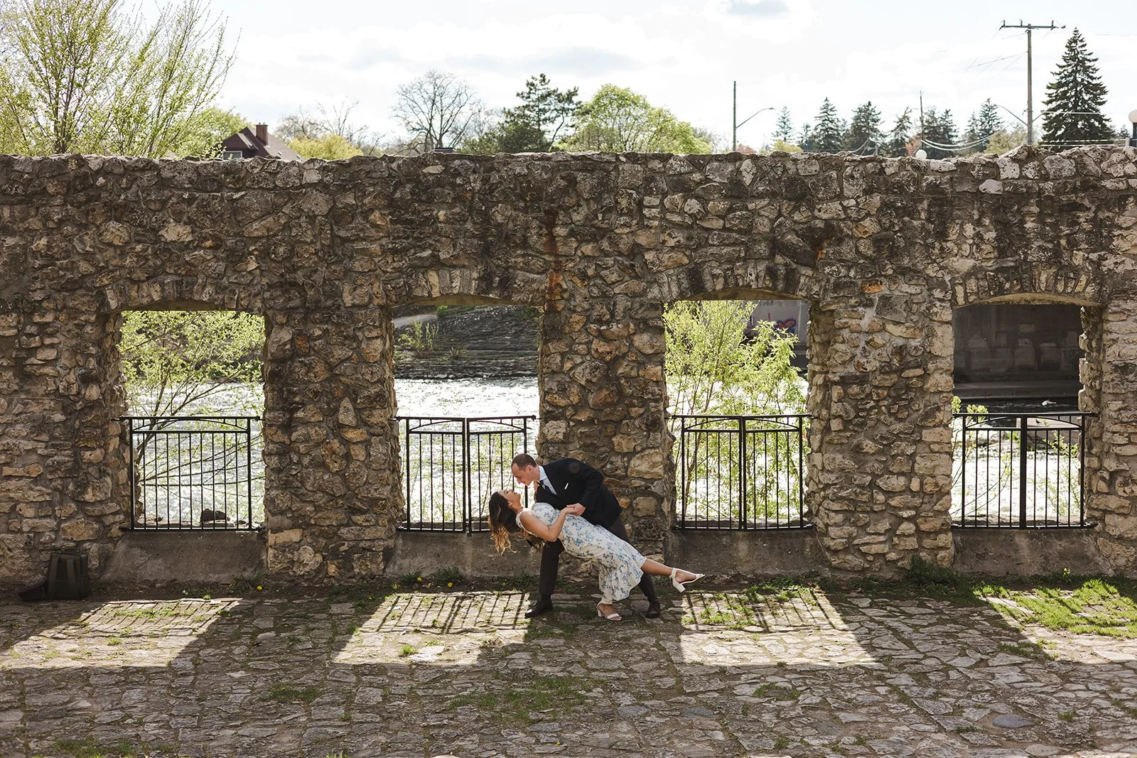 Couple dipping in front of stone wall  Ontario Engagement  Fedora Media.jpg