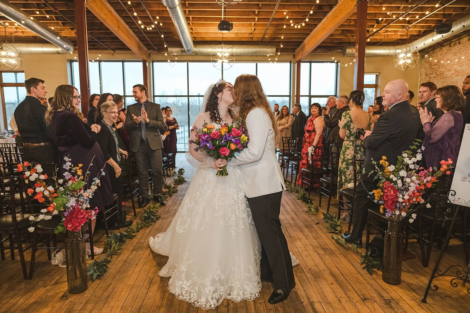 Bride and groom kiss in weddng aisle  Rivers Edge  Paris, ON  Fedora Media.jpg