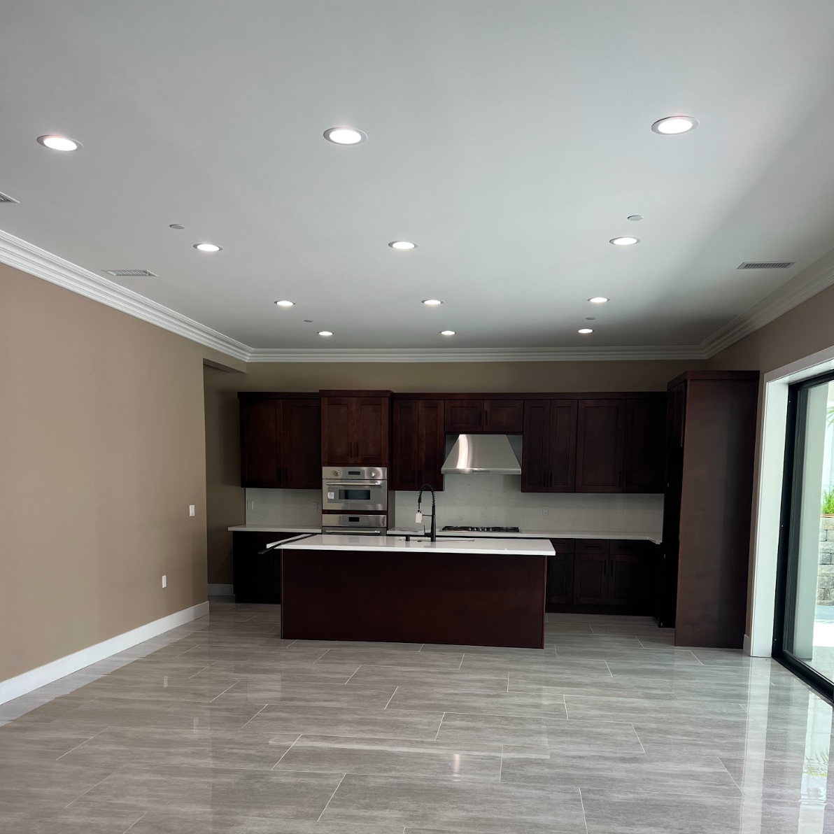 Open kitchen and living area with recessed ceiling lights