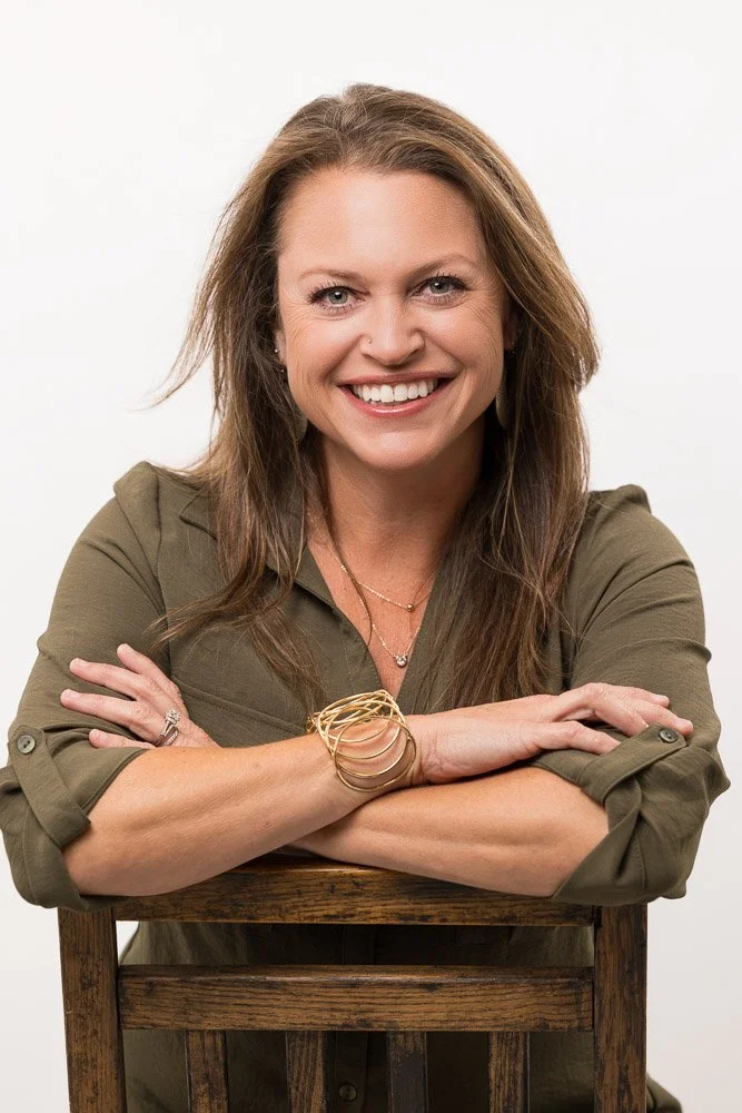 woman in wooden chair with green shirt