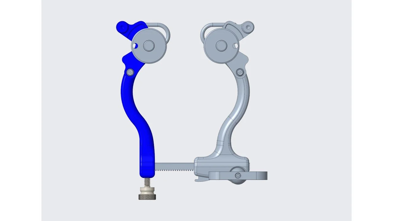 A digital illustration of a mechanical device with two curved arms, one blue and one gray, connected by a screw and gear mechanism at the bottom, with circular components at the top.