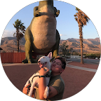 Two children hugging in front of the giant