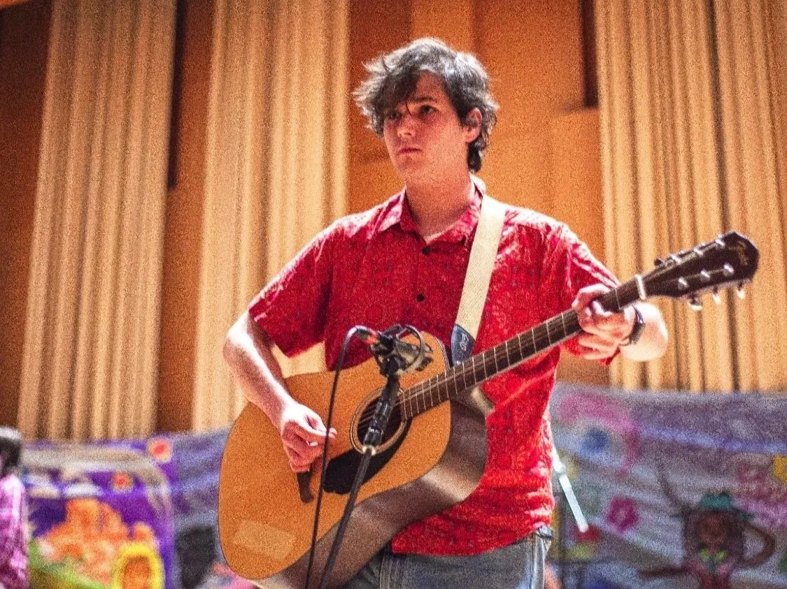 Cathal Mayfield playing his acoustic guitar during Tabasco Bird gig at Paul Voertman Concert Hall (May 2025). Photo credit to @parkermollenski. | Denton's premiere cosmic country band. Music available on all streaming platforms. Est. 2024