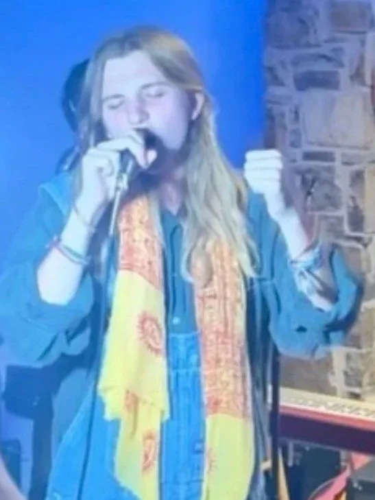 Jake Bullman standing and singing during Tabasco Birds house show performance (September 2025). Photo credit to @parkermollenski. | Denton's premiere cosmic country band. Music available across all streaming platforms. LPs/CDs. Flying since 2024!