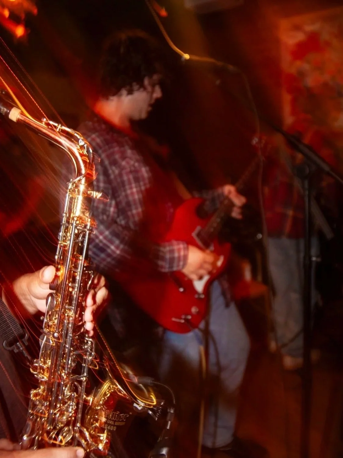 Blurry photo of Cathal Mayfield during a Tabasco Birds show at Aura Coffee, Denton TX (October 2025). Photo credit to Jackson Holmes. | Denton's premiere cosmic country band. Music available across all streaming platforms. LPs/CDs. Flying since 2024