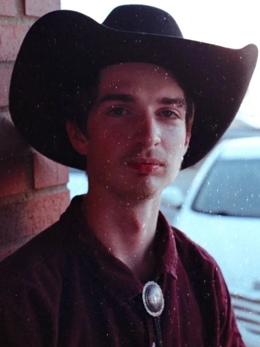 Logan Bolen wearing a cowboy hat and bolo tie (August 2024). Photo credit to Abe Randle. | Denton's premiere cosmic country band. 'Cosmic American Music' available on all streaming platforms. LPs/CDs. Flying since 2024!