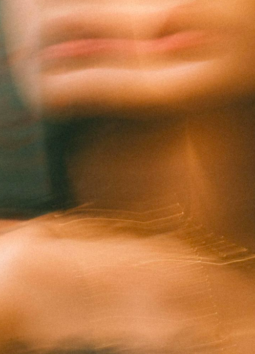 An abstract image with blurred, wavy lines and soft, muted colors.