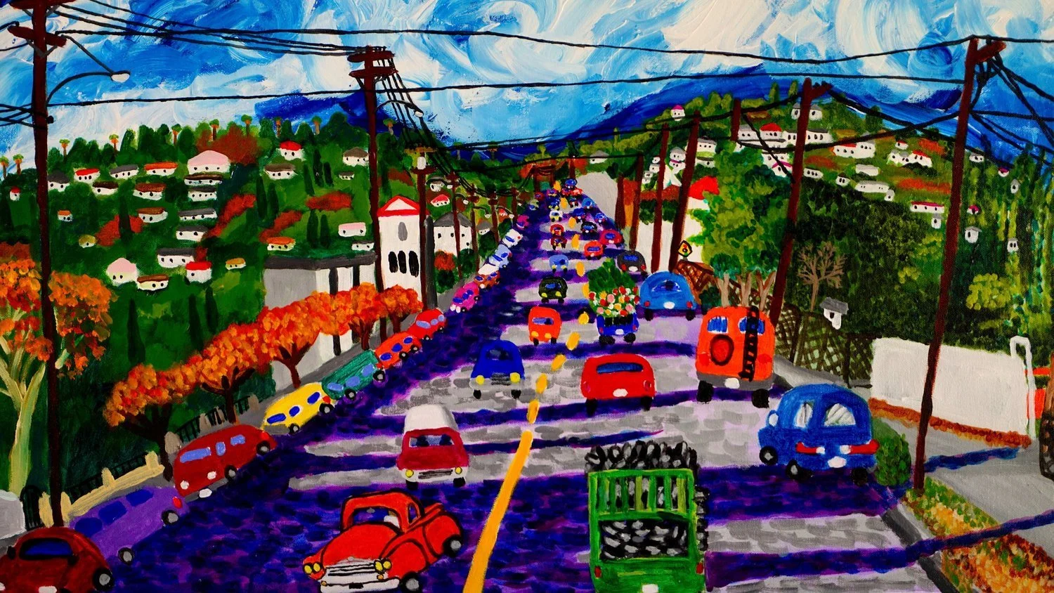 colorful Roberto Gutierrez painting of cars on a road hills on the side and sky in the background