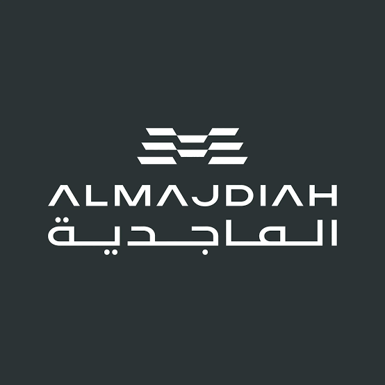 Logo with stylized white design above the text 'ALMAJDIH' and its Arabic translation on a dark background.