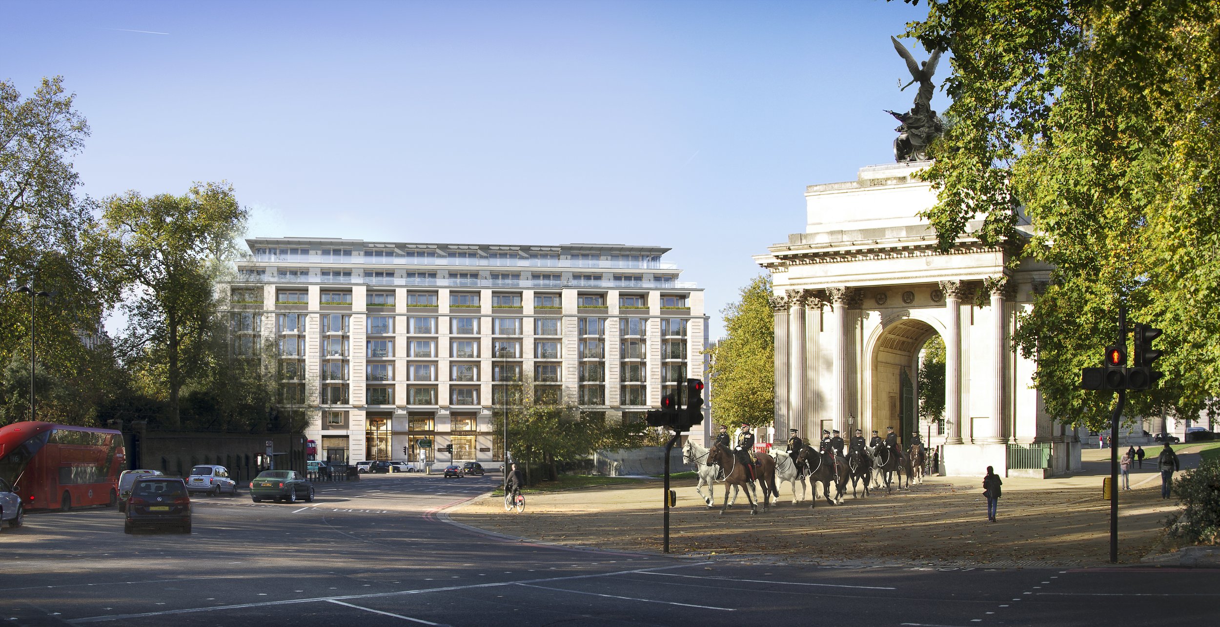 A city scene with a historic archway featuring a statue on top, surrounded by a line of mounted police officers, modern apartment buildings, cars, a bus, trees, and traffic lights on a sunny day.