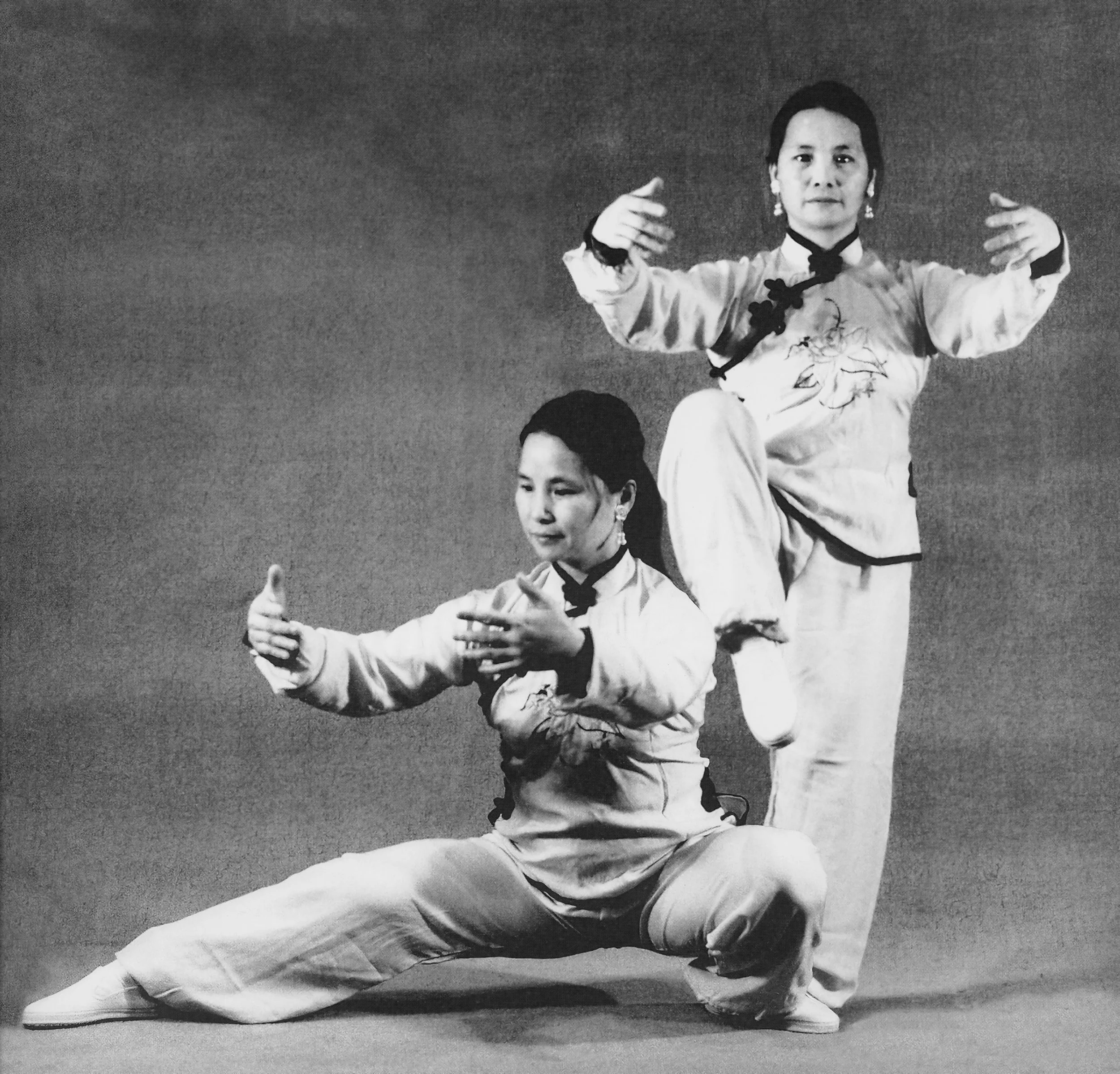 Bow Sim Mark strikes two Tai Chi poses in an early black-and-white photograph.