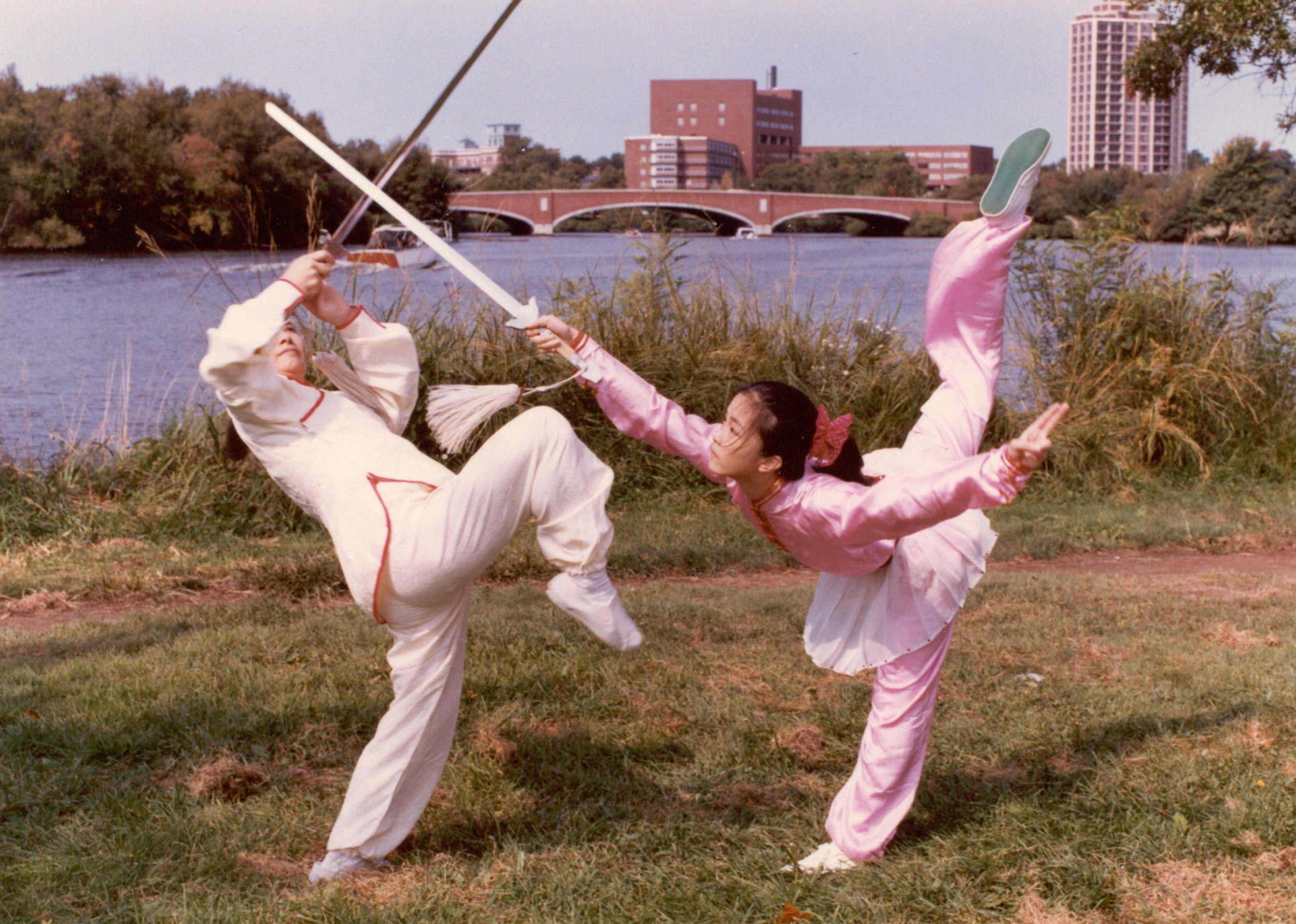 Bow Sim Mark and her daughter Chris Yen in a beautiful Wudang sword duet together, each wearing traditional silk attire.
