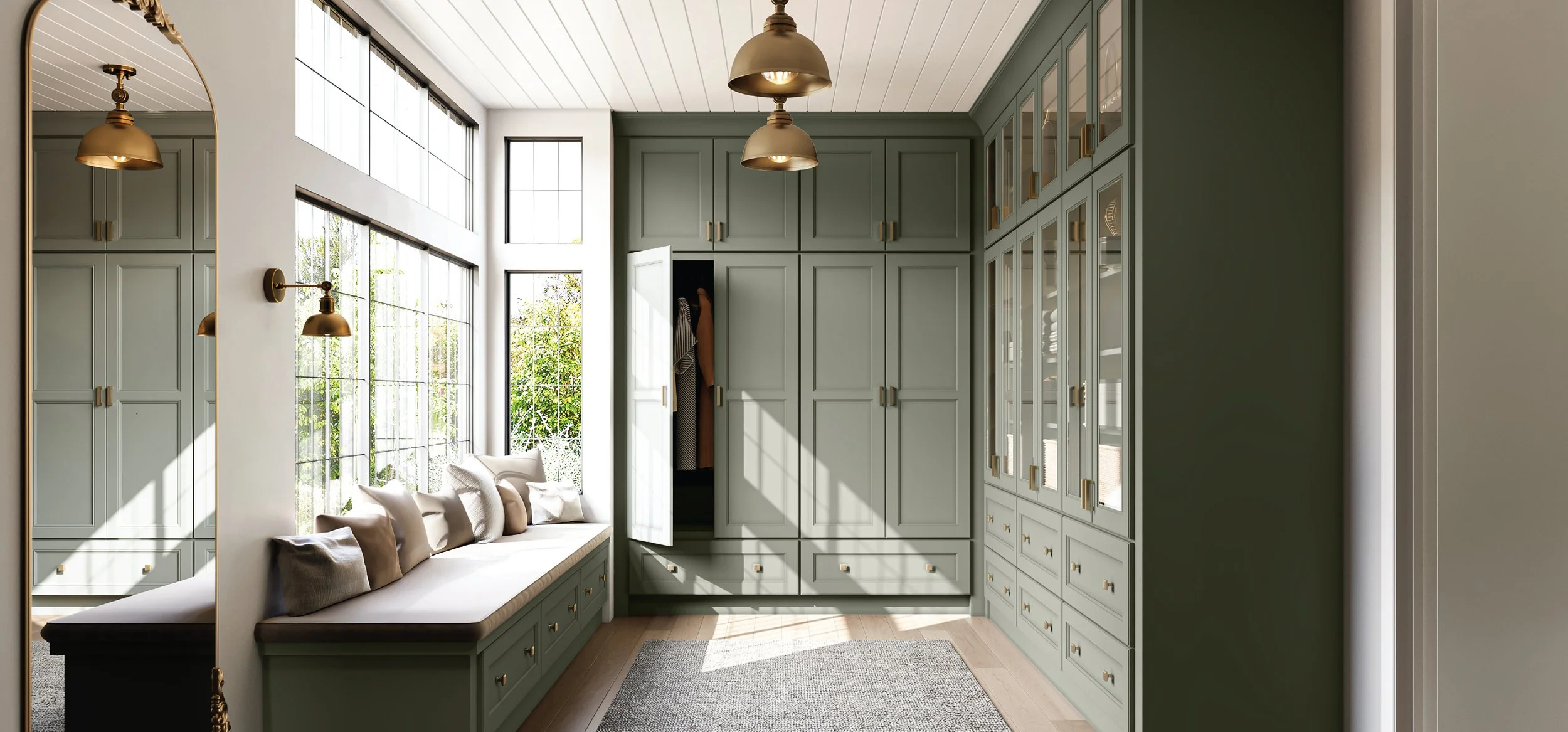 Cozy walk-in closet with gray built-in cabinets, a window seat with pillows, large windows, and hanging light fixtures.