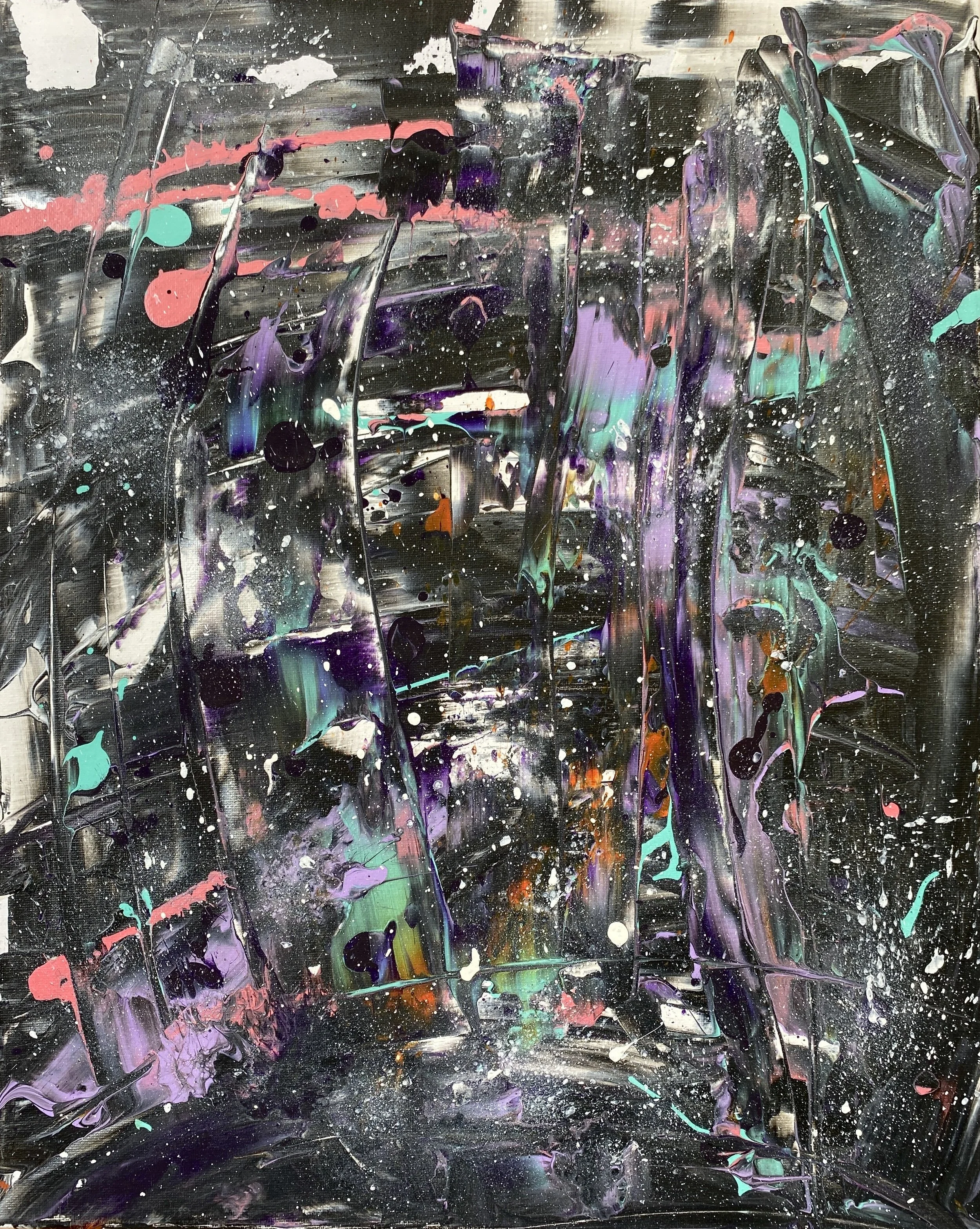 Abstract acrylic paint splatters on a canvas with black, purple, green, pink, white, and orange colors creating a chaotic pattern.
