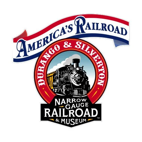 Logo for America's Railroad Exhibition featuring a steam locomotive inside a red circle, with text indicating it's a Narrow Gauge Railroad and Museum in the United States.