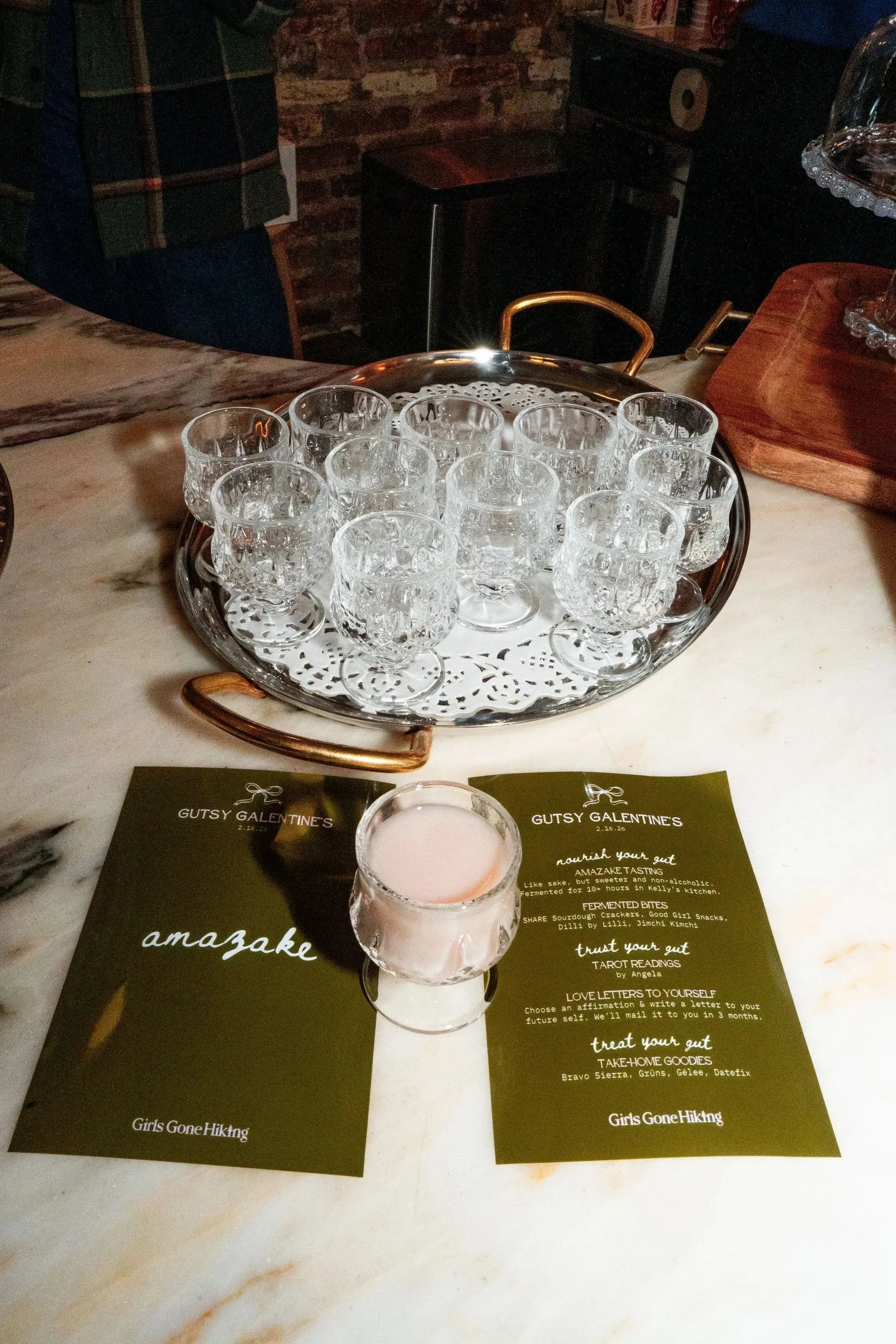 Tray of small crystal glasses for an amazake tasting for Galentine's hosted at Bedford Studio in the West Village NYC.