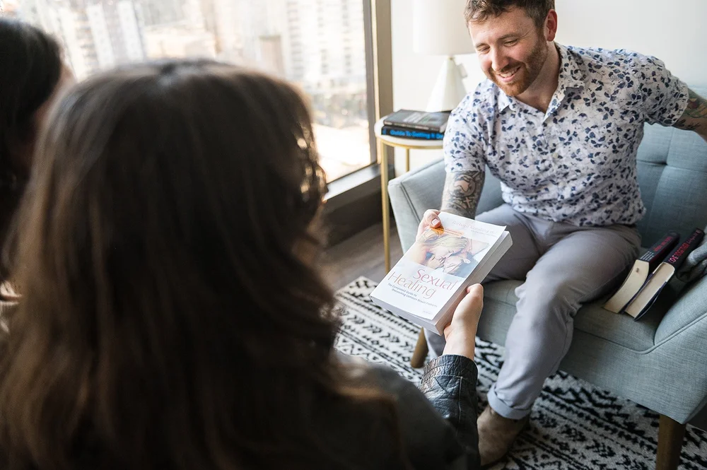 A client and counsellor sharing a counselling resource in an Allura counselling room.