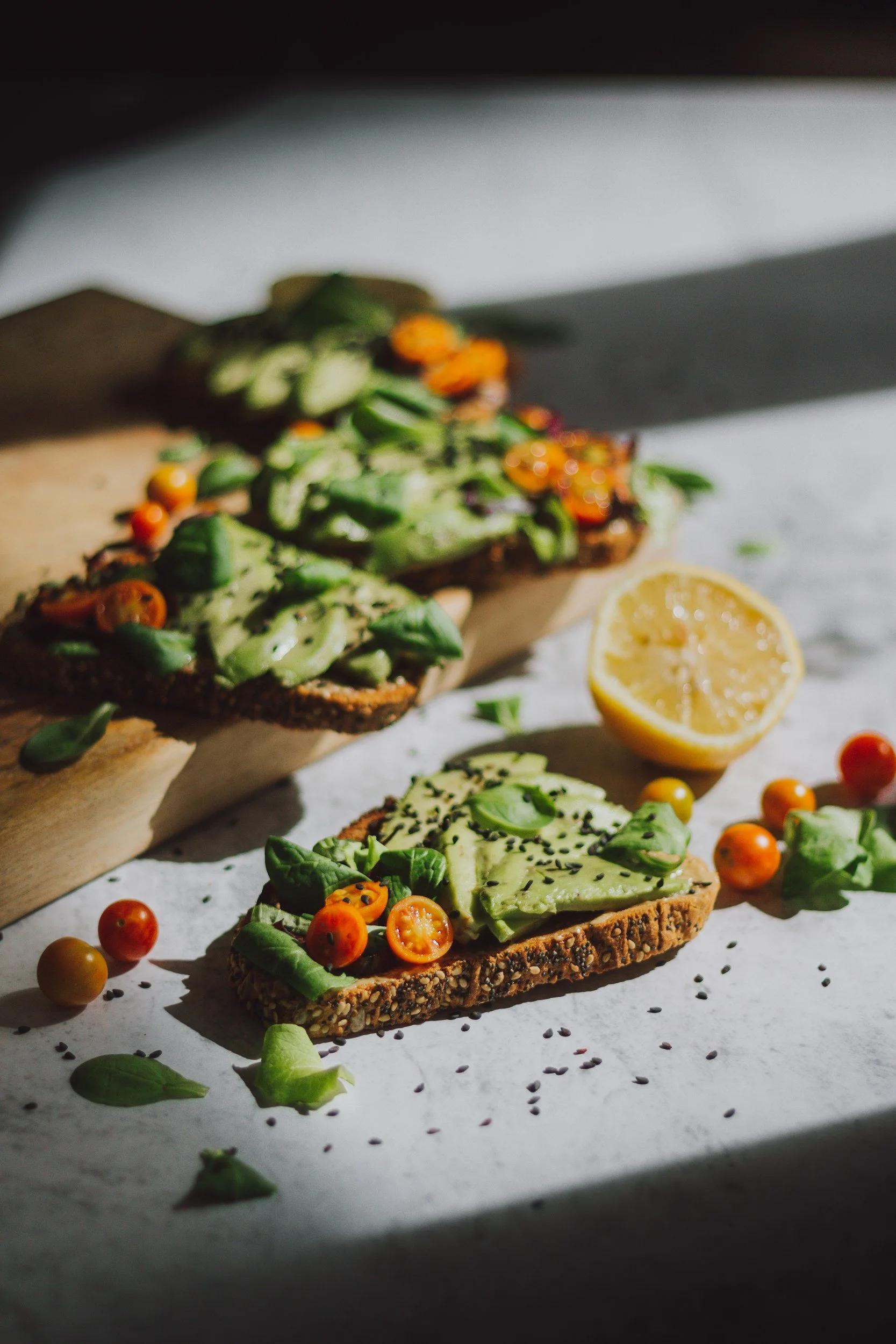Avocado toast topped with cherry tomatoes and herbs at The Soul Space Wellness Café + Shoppe in Panama City, Florida, representing wholesome, nourishing food offerings.