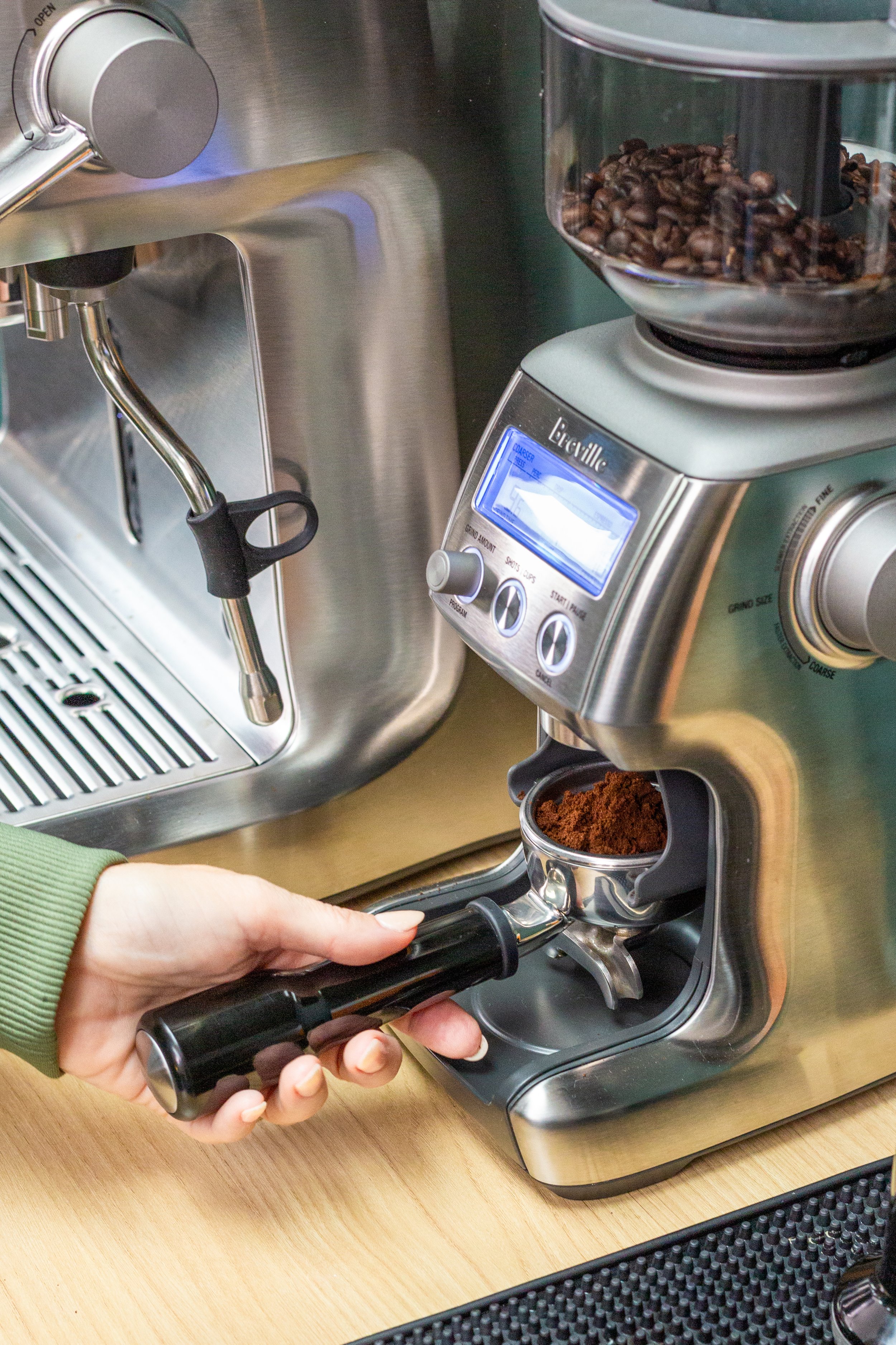Fresh espresso beans being ground for handcrafted coffee drinks at The Soul Space wellness café in Panama City, Florida