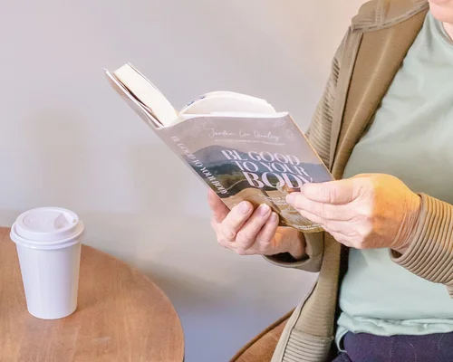 A guest reading with a latte at The Soul Space