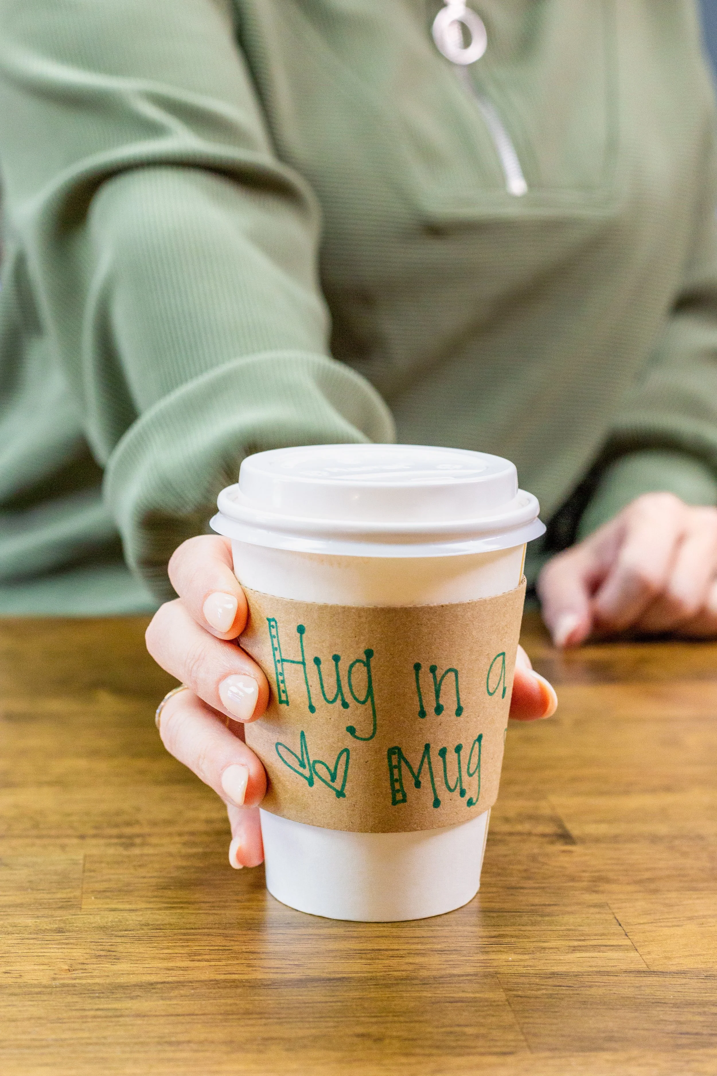 Hot coffee in a takeaway cup at a Panama City Florida coffee shop and wellness café