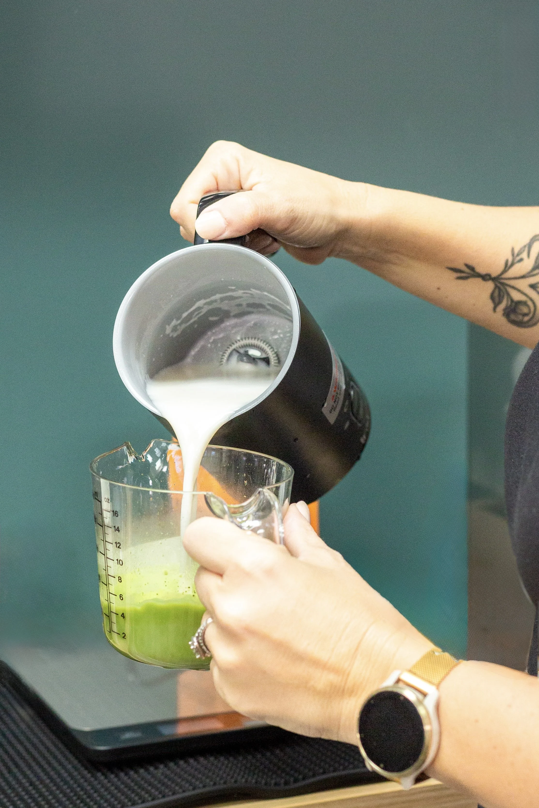 Milk poured into a matcha latte prepared fresh at The Soul Space café in Panama City, Florida
