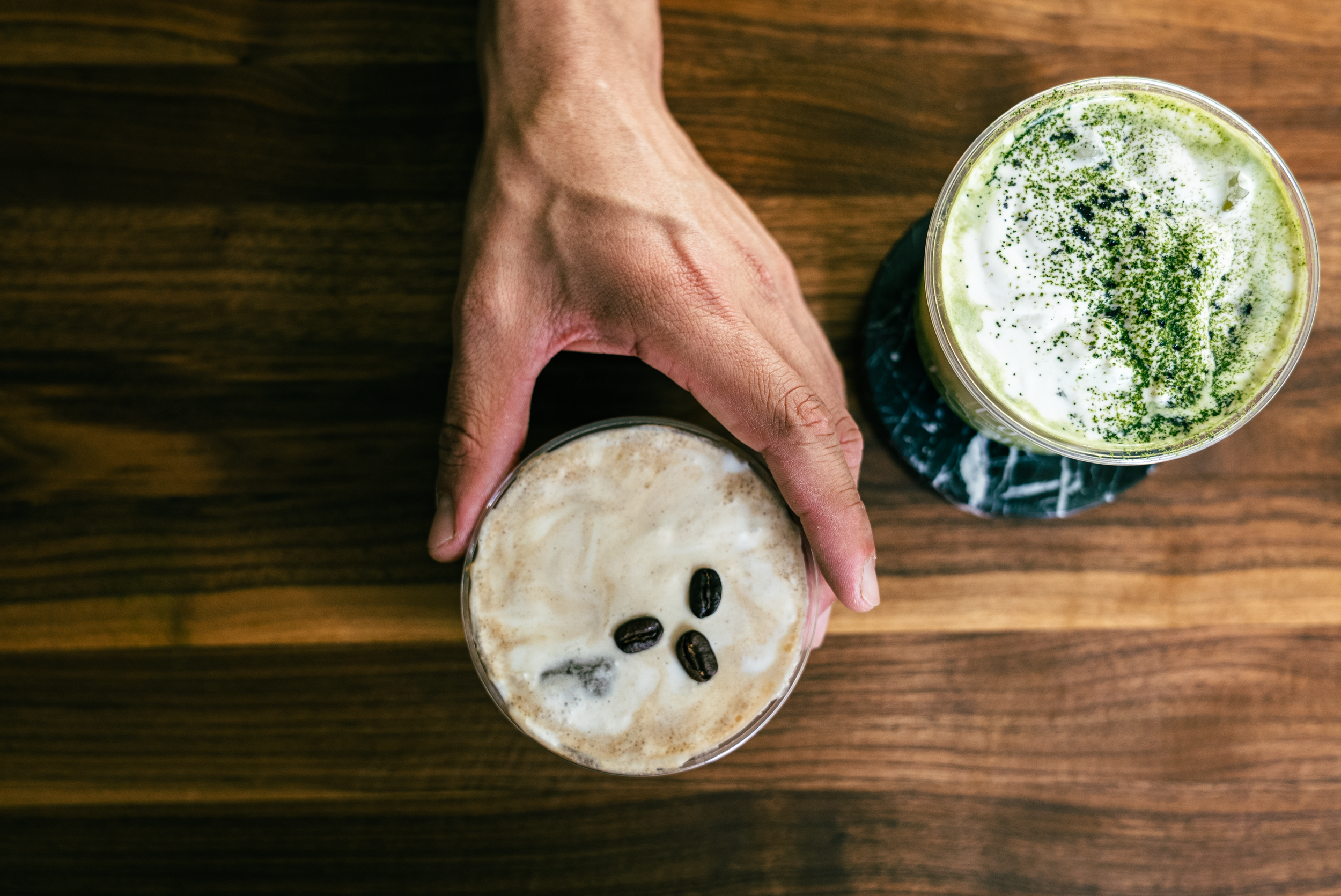 Top-down view of a matcha and cold brew drink from The Art of Roam