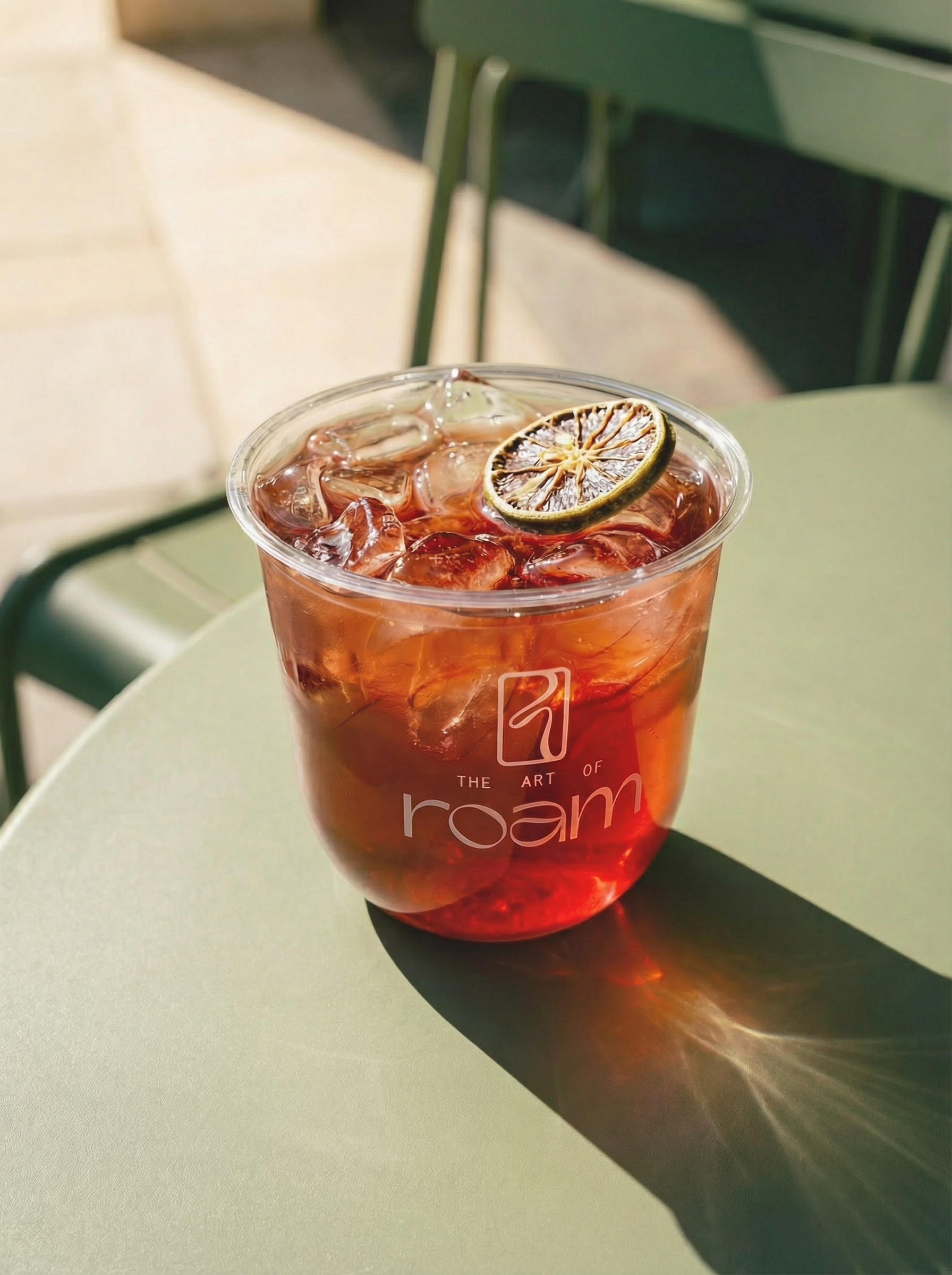 Red lemonade drink displayed on a table in a The Art of Roam cup

