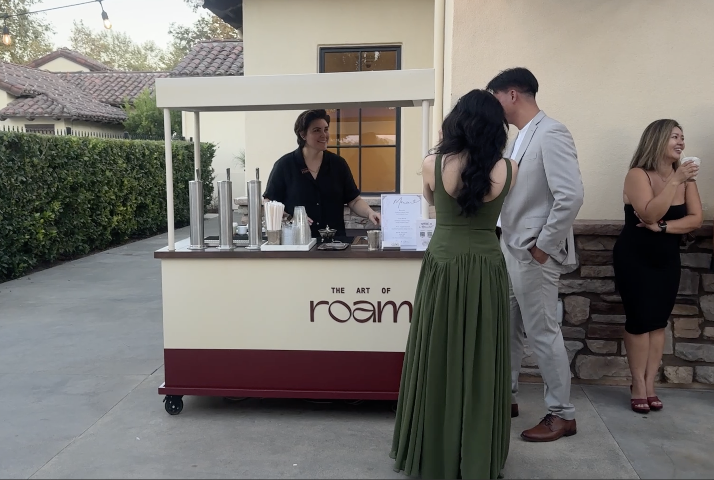 Happy wedding guests at coffee cart.png