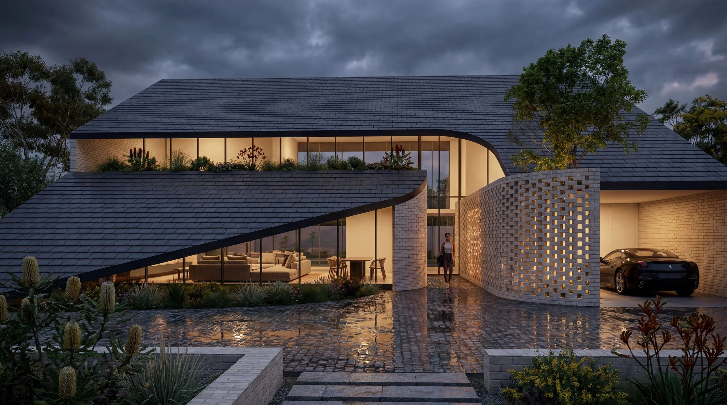 Modern two-story house with a sloped dark roof, large glass windows, a garden with cacti and plants, and a patio area with outdoor furniture. Light from inside illuminates the scene during evening or dusk, with dark, cloudy skies overhead.