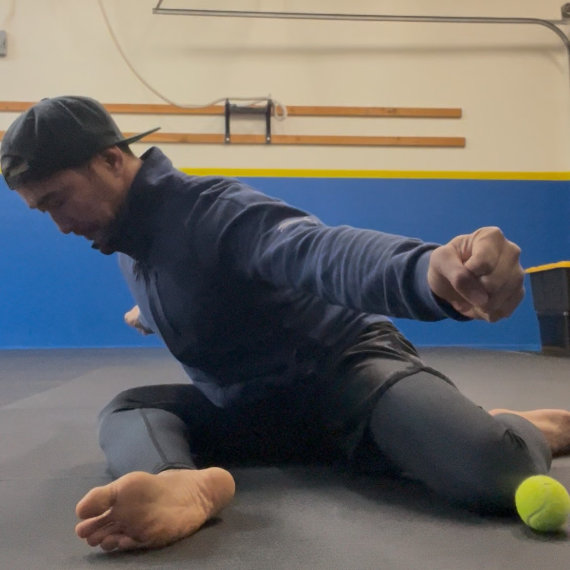 Person in athletic clothing doing a 90/90 stretch