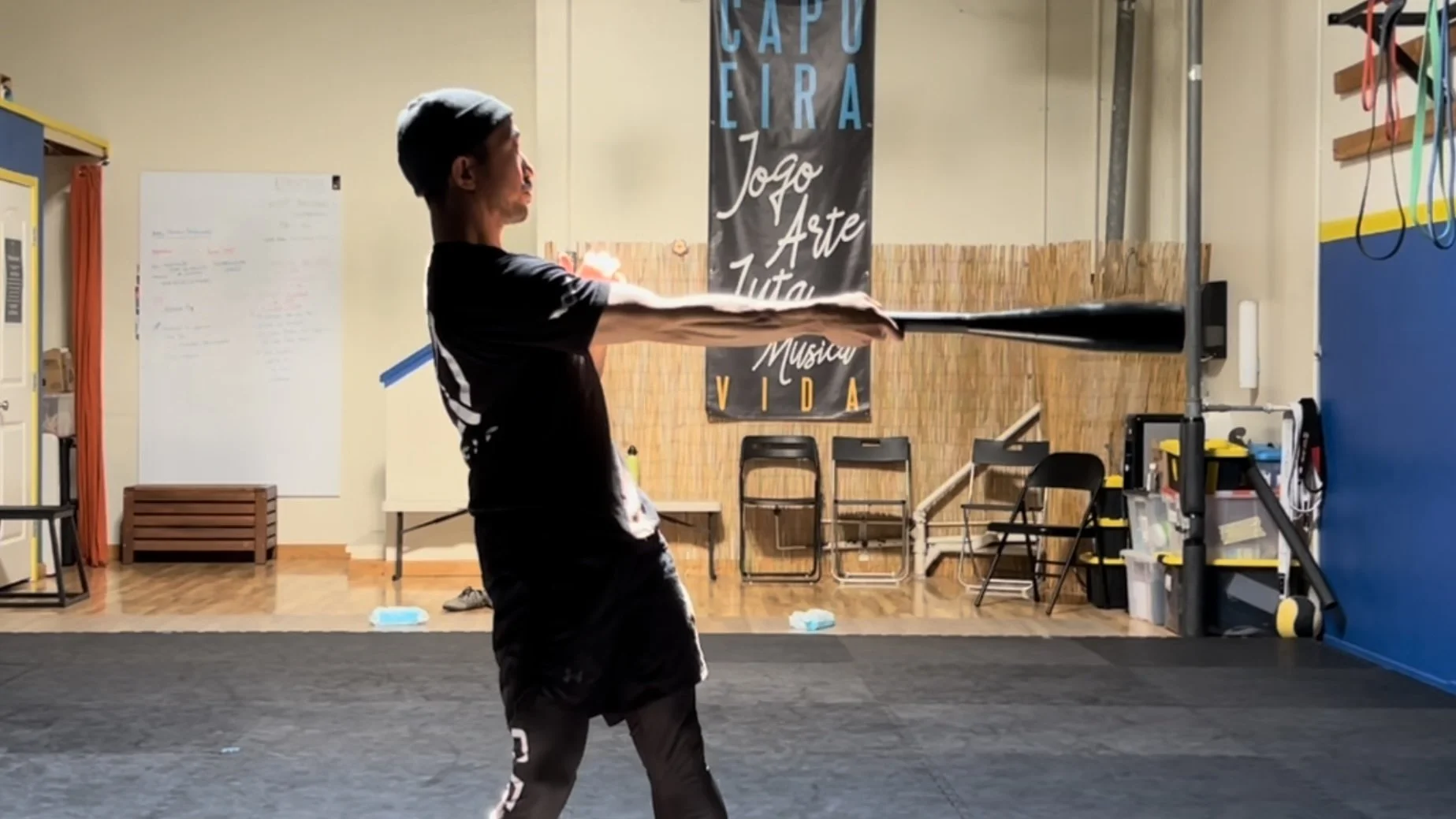 Person swinging a clubbell in a gym