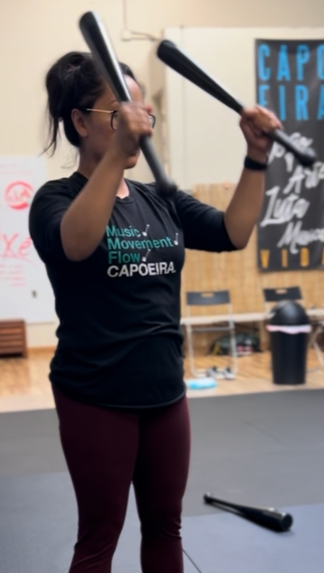 Woman exercising with 2 clubbells