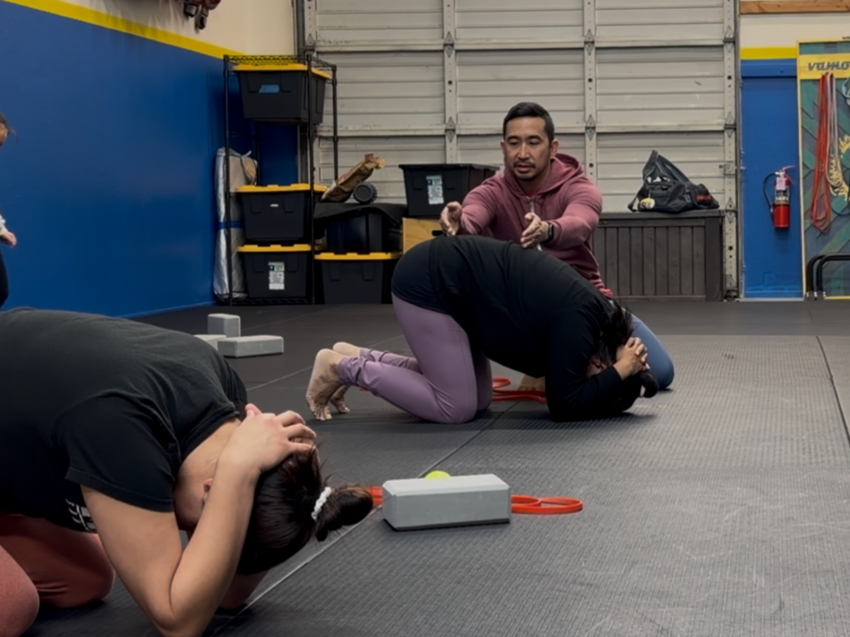 Coach Alfred providing personal instruction to a group training session.