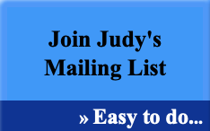Blue sign with black and white text reading 'Join Judy's Mailing List » Easy to do...'