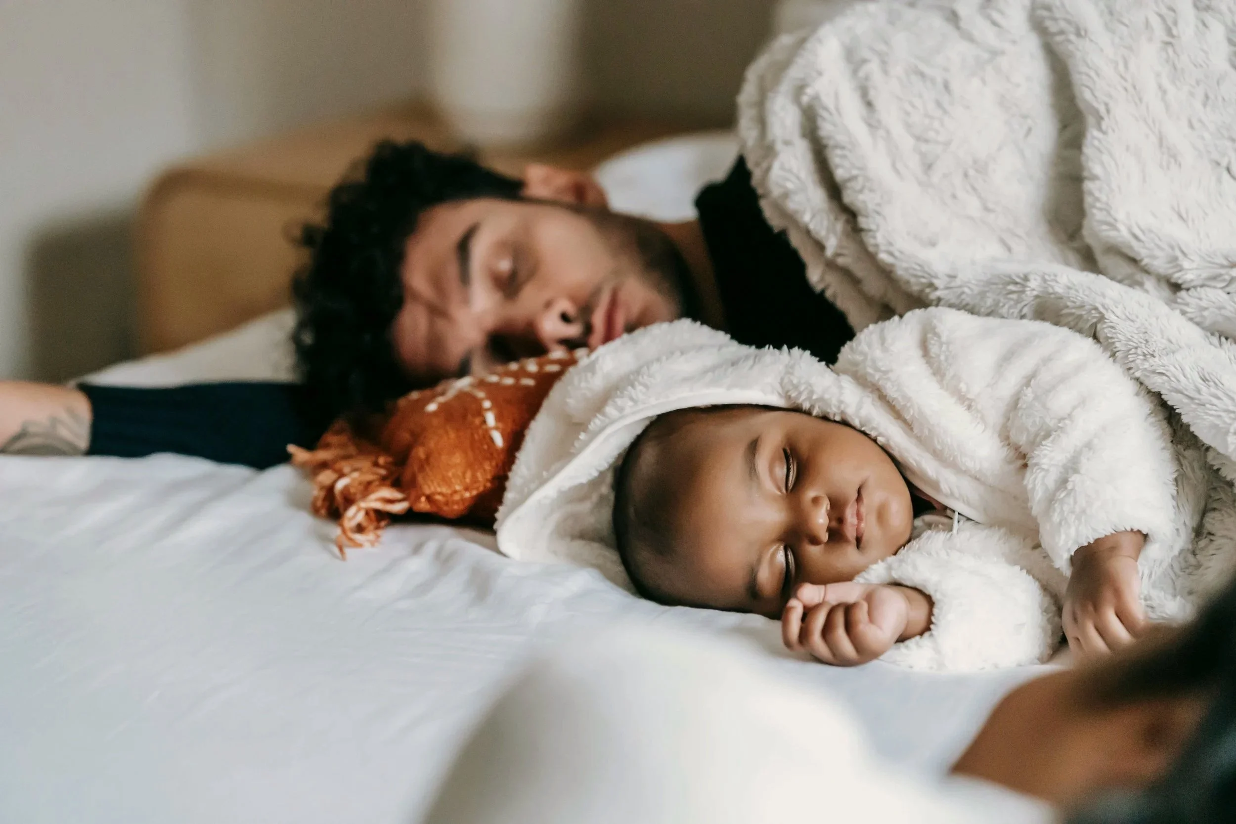 Baby and dad napping together