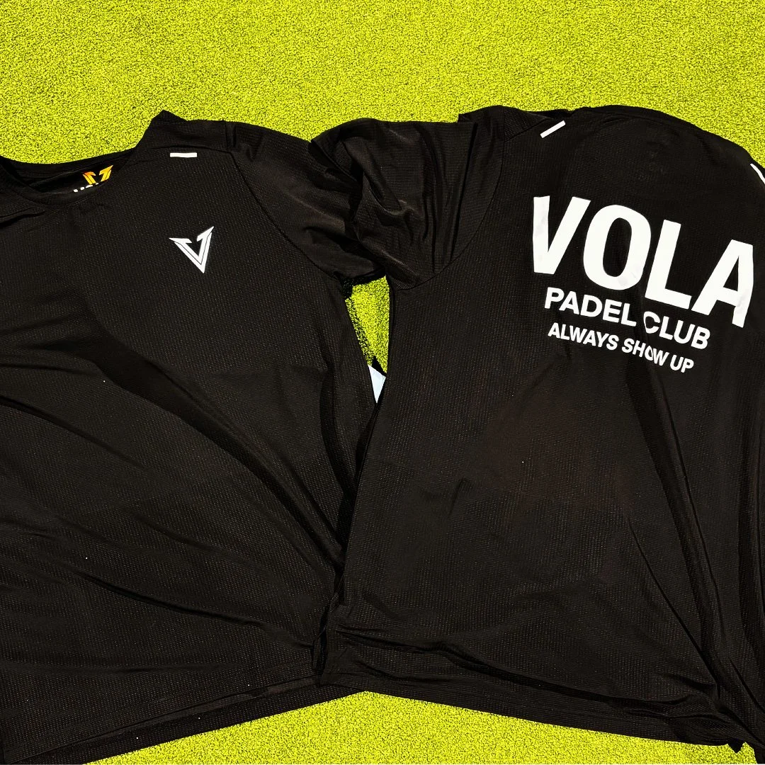 Two Vola Padel Club t-Shirts laying on the court.
