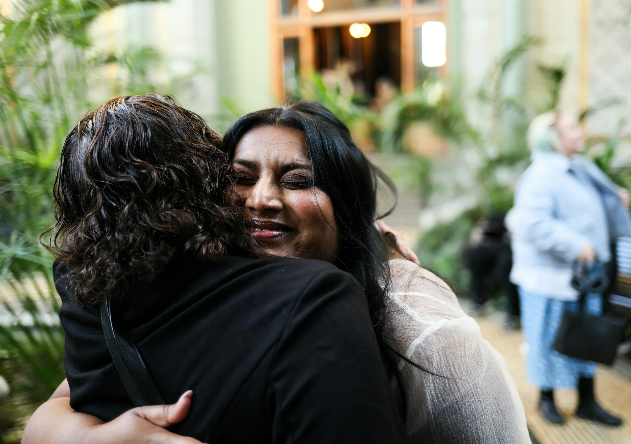 Person gently hugging a friend, symbolizing the hidden cost of being the emotional caretaker in relationships