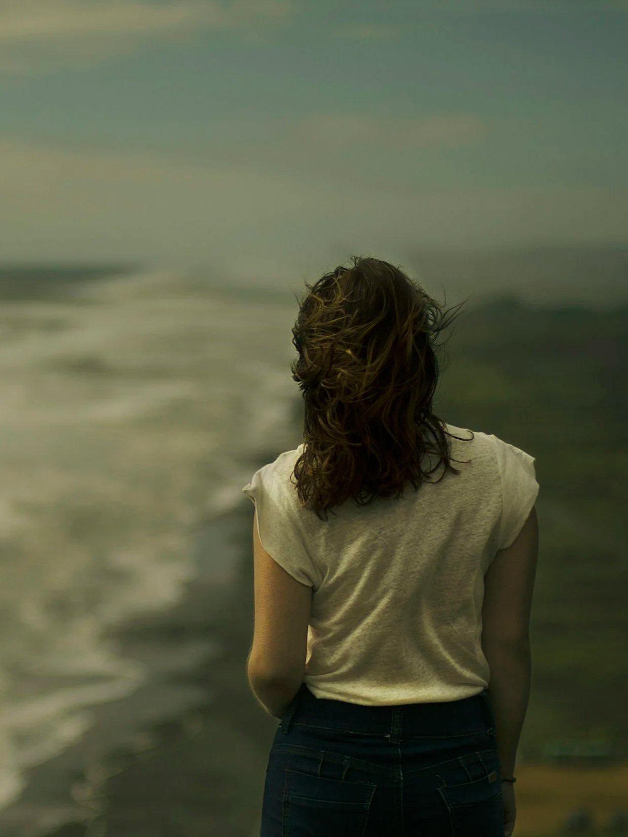 Person walking in a natural setting, representing somatic therapy for grief and loss