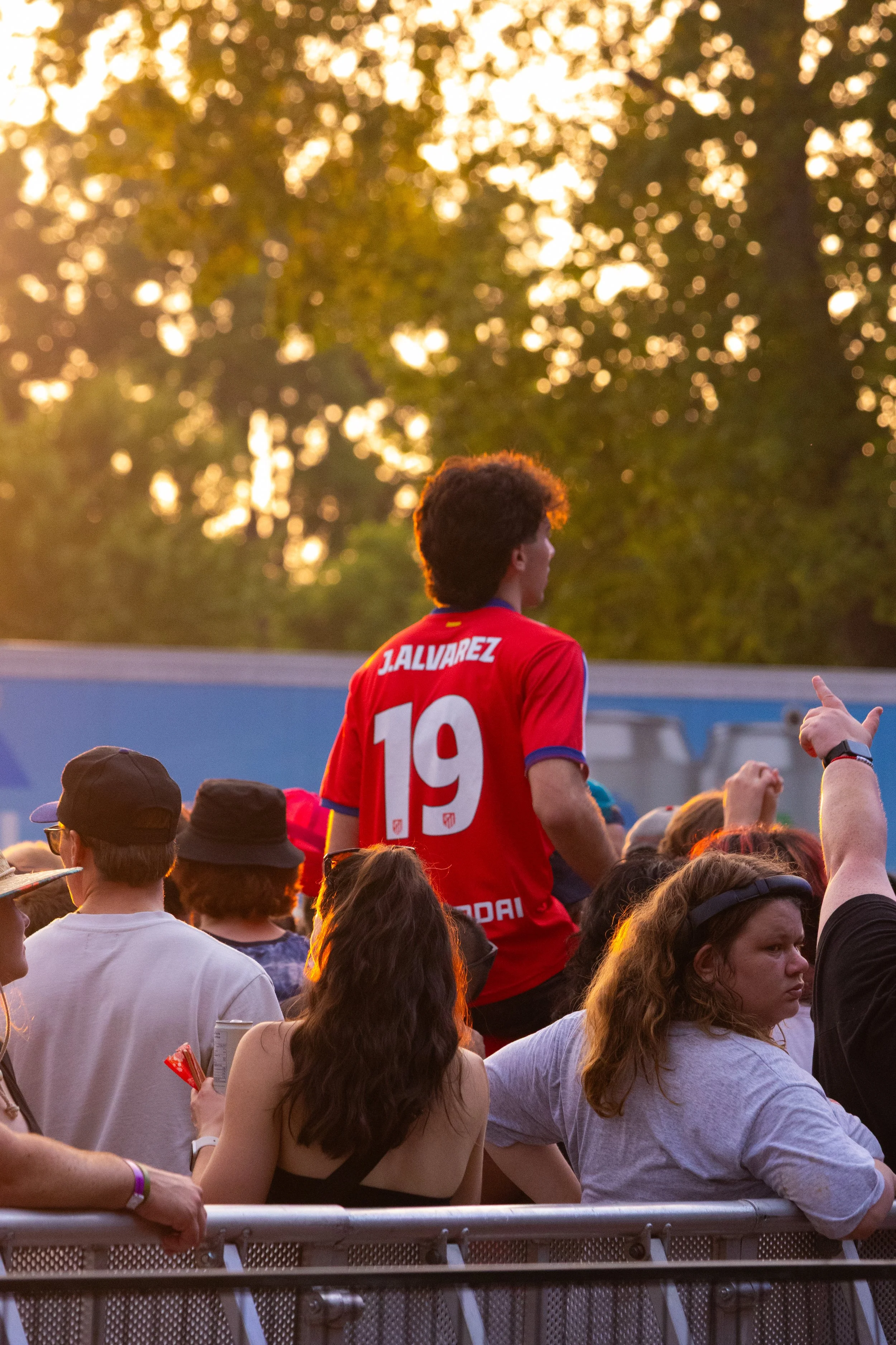 Guy sitting on shoulders as sun sets
