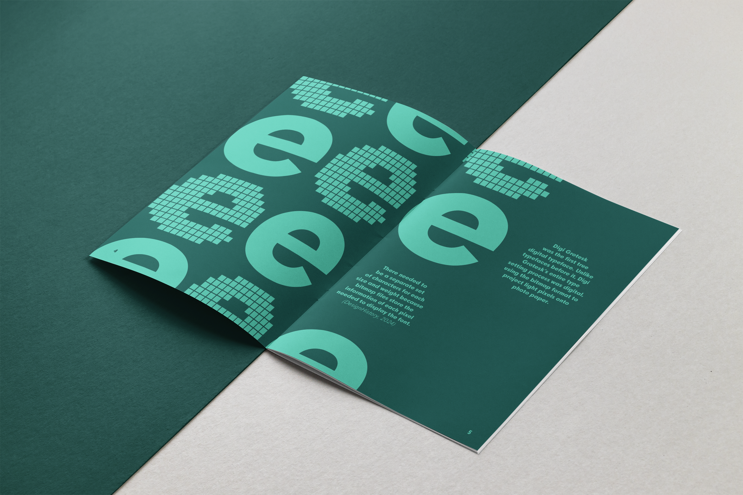 Open magazine or brochure with teal and dark green pages, featuring digital graphic design with pixelated numbers and small text.