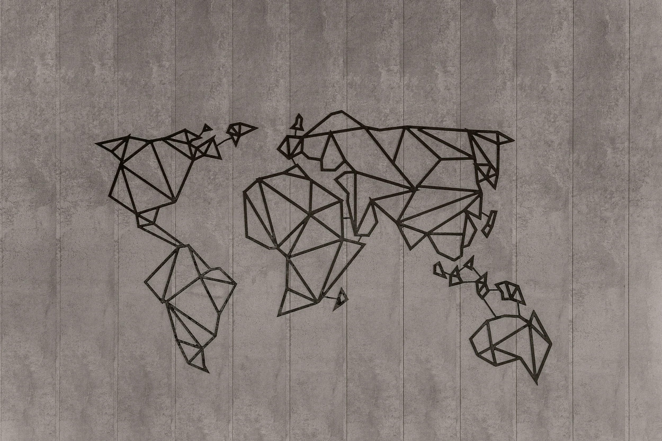 A wireframe map of the world displayed on a concrete wall.