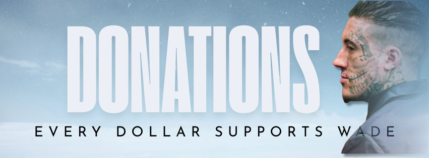 Side profile of a man with tattoos on his face and neck, wearing a gray jacket, looking to the right, in front of a snowy background with the words 'DONATIONS' and 'EVERY DOLLAR SUPPORTS WADE'.
